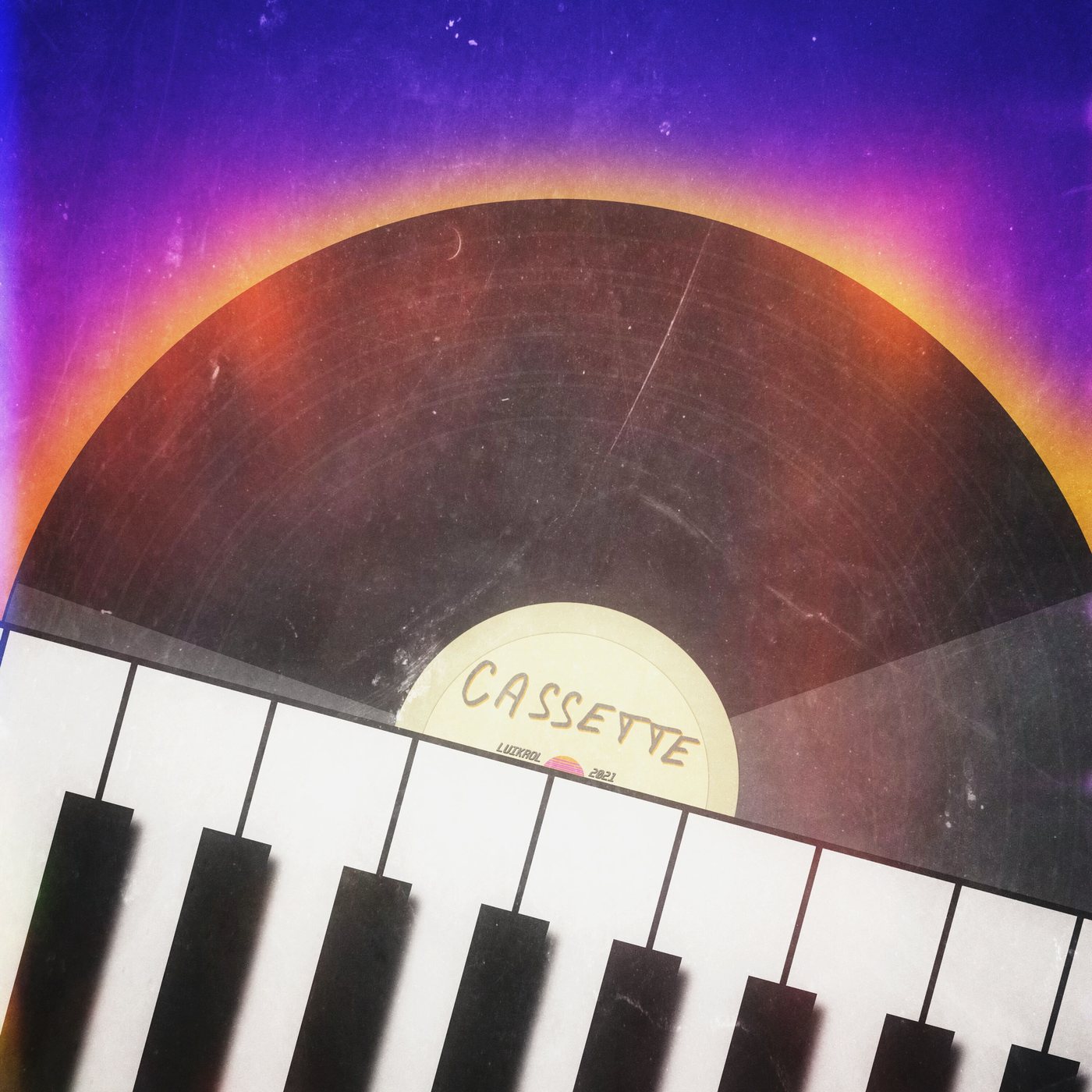 Cassette label over a vinyl record and piano keys, marked Luikrol 2021