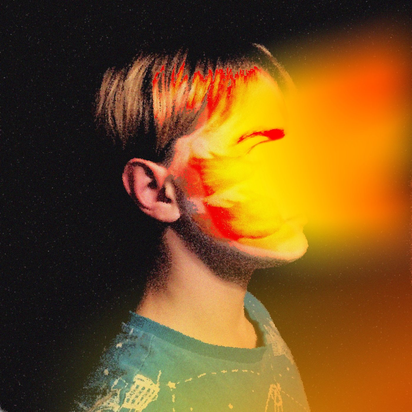 Grainy profile portrait washed in orange and yellow light