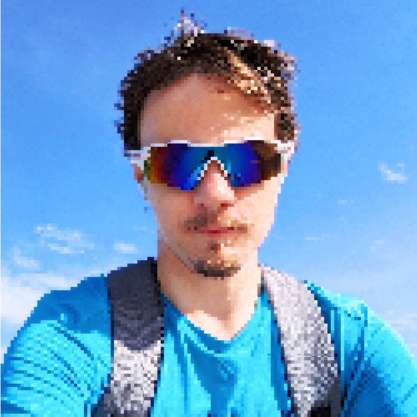 Selfie in white sunglasses and a blue shirt against a clear sky